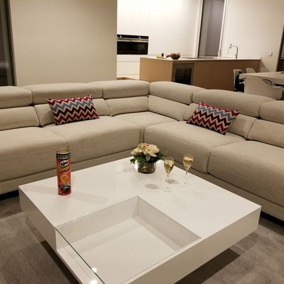 Inside the seating area of the living room of Casa Madroño with the kitchen in the background